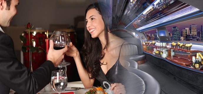 man and woman enjoying drink in a limousine